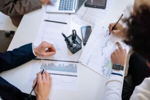 financing advisor Business team analyzing financial charts and graphs during a collaborative meeting.
